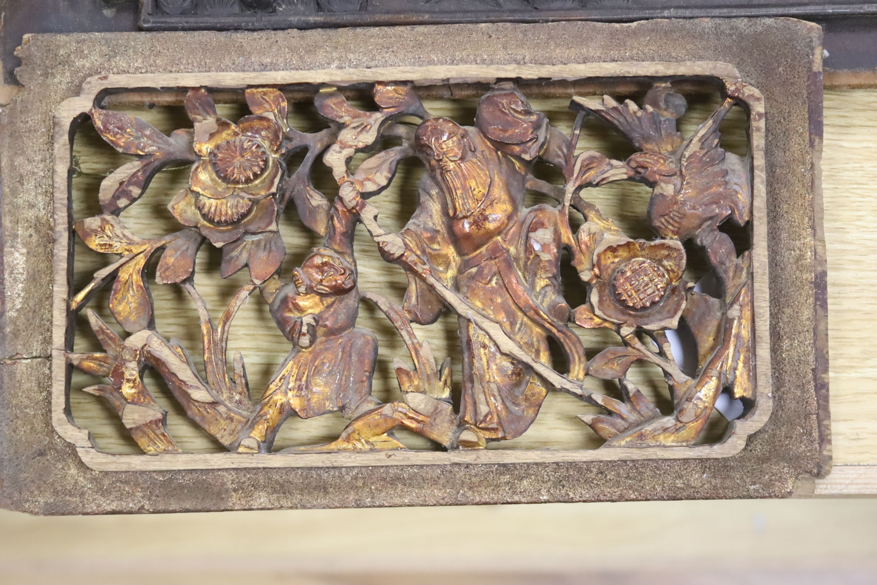 Three Chinese gilt wood carvings, largest 33.5cm and a wood panel 36.5cm